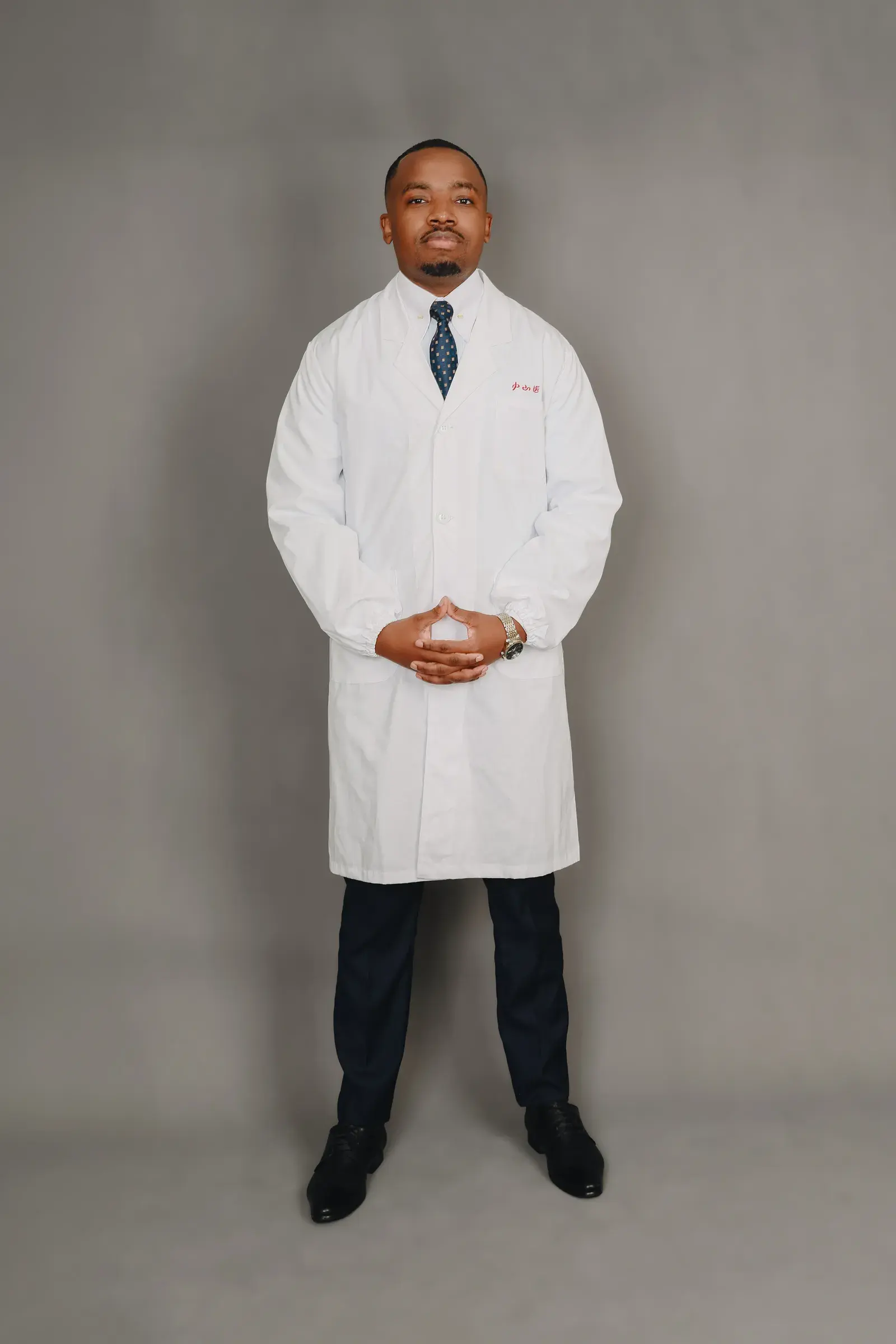 Dr. Pascal Kwangwari in a white coat