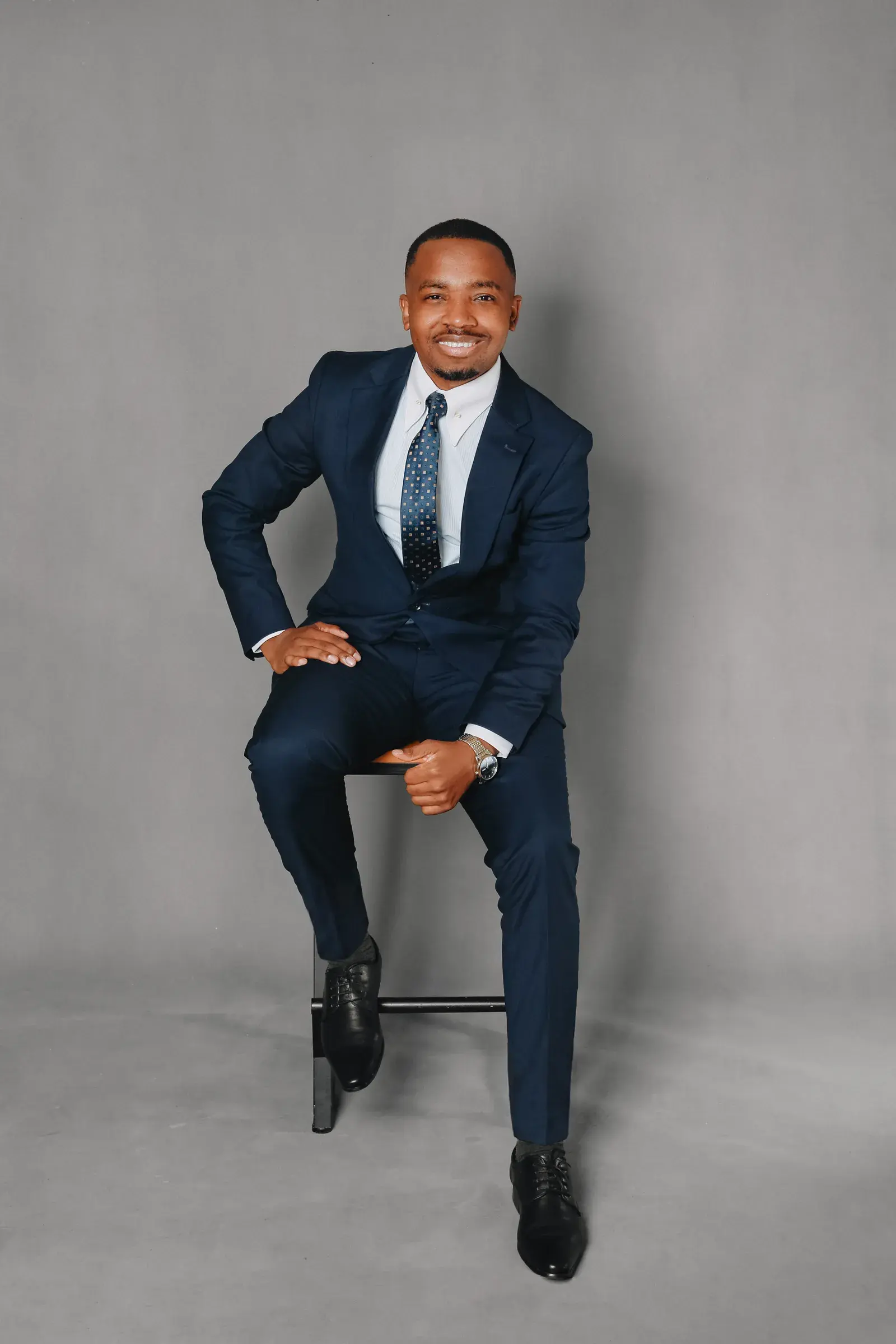 Dr. Pascal Kwangwari in a navy suit